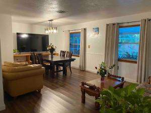 a living room with a table and a dining room at Family Vacation Home with Pool in Sarasota