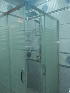 a shower with a glass door in a bathroom at Famili home in Ganja