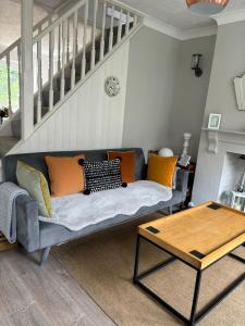 a living room with a couch and a table at Sea Song Cottage in Broadstairs