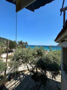 a view of the beach from the balcony of a house at K. Villa - Golden Beach in Chrysi Ammoudia