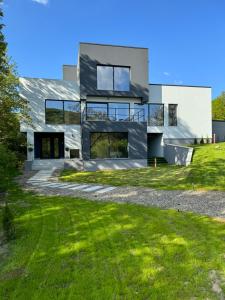 a house on a hill with green grass at Casa Alma in Piatra Neamţ