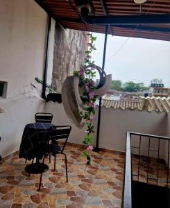 a room with a table and chairs and a plant at La Alborada Casa boutique in Villavicencio