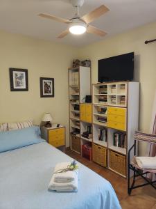 a bedroom with a bed and a flat screen tv at Lluna Beach Bará in Roda de Bará +49 photos