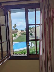 a window with a view of a swimming pool at Lluna Beach Bará in Roda de Bará