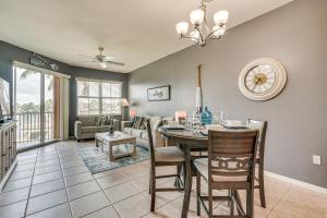 a dining room and living room with a table and chairs at Bayfront Punta Gorda Condo Rental with Pool Access! in Burnt Store Marina