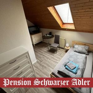 a small bedroom with a bed and a skylight at Pension Schwarzer Adler 
