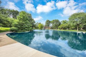 a swimming pool in a park with trees at Housepitality - The Short North Sanctuary in Columbus