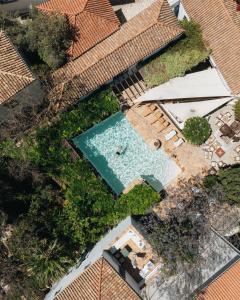 an overhead view of a swimming pool with chairs and plants at Bratsera Boutique Hotel in Hydra