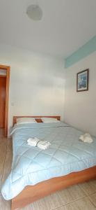 a bedroom with a bed with two towels on it at THALASSA - 2 Bedroom seaside appartment in Polychrono