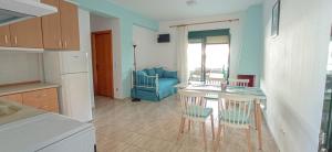 a kitchen with a table and chairs in a room at THALASSA - 2 Bedroom seaside appartment in Polychrono