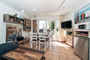 uma cozinha e sala de estar com uma mesa e um sofá em Ferienwohnung "Ostseeperle" direkt am Ostseestrand em Kronsgaard