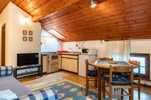 a kitchen and dining room with a table and chairs at Residenza Panarotta - Vetriolo(1500m) in Levico Terme