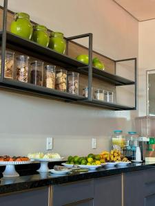 a kitchen with plates of fruit on a counter at Hotel Skalla in Teixeira de Freitas