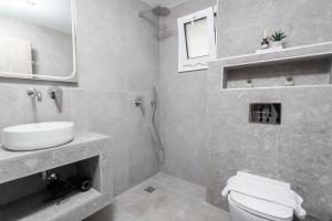 a bathroom with a sink and a toilet at Paula luxury living by the sea in Pefkohori