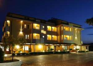 un grande edificio di notte con luci accese di Hotel Maria a Pineto