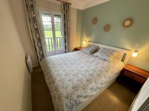 a bedroom with a bed and a window at Maison les pieds dans l'eau, piscine et plage à pieds in Moliets-et-Maa +13 photos