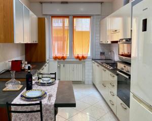 a kitchen with a table with plates on it at Venice Travel Dream Spacious Apartment near Venice in Mestre