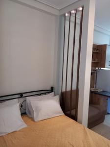 a bed with two white pillows in a room at Cozy Karystos Apartment in Karistos