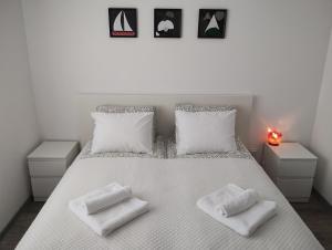 a bedroom with a white bed with two white pillows at Happy Apartment & Free Breakfast - Mladost in Sofia +10 photos