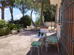 two chairs and a table on a patio at Litta in Collepasso