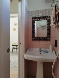 a bathroom with a sink and a mirror at Litta in Collepasso