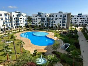a large swimming pool in front of some buildings at Appartement de Luxe Costa-Mar Martil Tetouan in Martil
