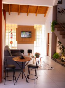 a living room with a couch and a table at Hotel Paradouro in Alfredo Wagner