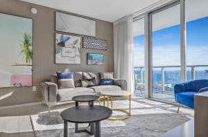a living room with a couch and a table at Wake Up To Ocean Views - Stunning 2BDR & 2BA Condo STEPS AWAY FROM THE OCEAN, NO RESORT & PARKING FEES, CHECK DETAILS in Hollywood