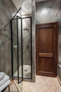 a shower with a glass door in a bathroom at Relais Giulia in Rome