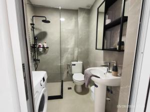 a bathroom with a shower and a toilet and a sink at Stefanie Apartment 2 Peraia in Perea
