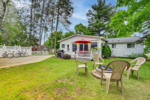 a yard with chairs and a table in front of a house at Boyne City Retreat Near Beaches and Mtn Resort! in Boyne City