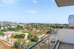 a balcony with a view of a city at 3 bedroom apartment in Gudja in Gudja