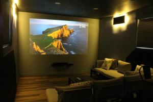a living room with a flat screen tv on a wall at Park side Basement 2 bedroom suite in Kelowna