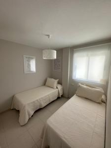 Katil atau katil-katil dalam bilik di Apartamento Los 8 Monumentos