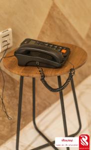 a phone sitting on top of a wooden table at سيتى للشقق المخدومة in Jeddah