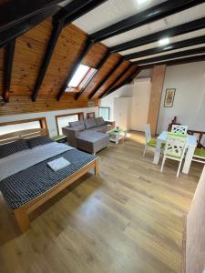a living room with a bed and a couch at Achillius apartmani Arilje in Arilje
