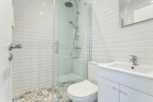 a bathroom with a shower and a toilet and a sink at BLife Farensya private rooms in Faro