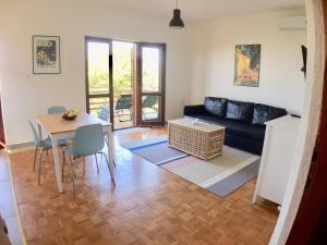 a living room with a couch and a table at Sea View Apartments Nini in Vlašići