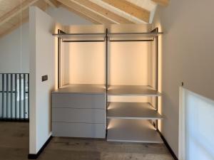 an empty refrigerator in a room with a ceiling at La Villa Viale Verdi in Novara