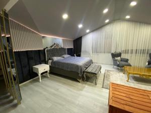 1 dormitorio con cama, silla y escritorio en Grand Zara Hotel, en Kayseri