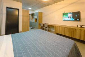 a hospital room with a bed and a flat screen tv at Apartamento Luxo Central - CA704 in Maringá