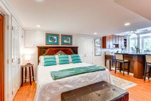 a bedroom with a large bed and a kitchen at Waterfront Columbia Studio with Patio and Sunroom! in Columbia