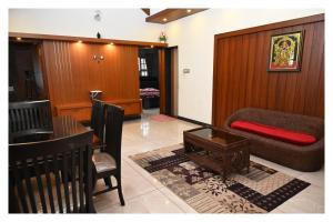 a living room with a couch and a table at Atithi Homestay, Udupi in Udupi