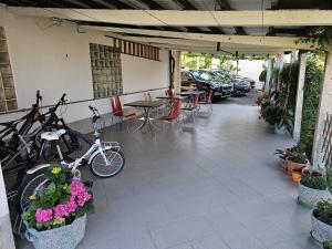 a patio with tables and chairs and bikes parked at Rooms Laguna Maresol in Jagodje