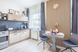 a kitchen with a table and chairs in a kitchen at Cozy studio at residential area - free street parking in Budapest
