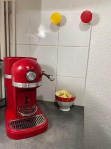 a red mixer sitting next to a bowl of food at Grand studio style bordelais dans le triangle d'or in Bordeaux