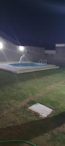 a large swimming pool in a field at night at CASA DUPLEX EM PENEDO 4 SUÍTES,FINS DE SEMANA e FERIADOS in Itatiaia