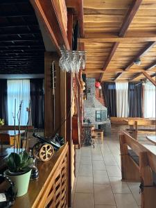 a dining room with wooden ceilings and a chandelier at B&B Lukač in Kutina
