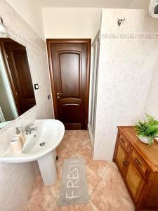 a bathroom with a white sink and a shower at Il tramonto tra Alghero e Stintino in Palmadula +45 photos