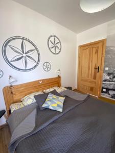 a bedroom with a bed with two pillows on it at Siwa Skała in Kościelisko
